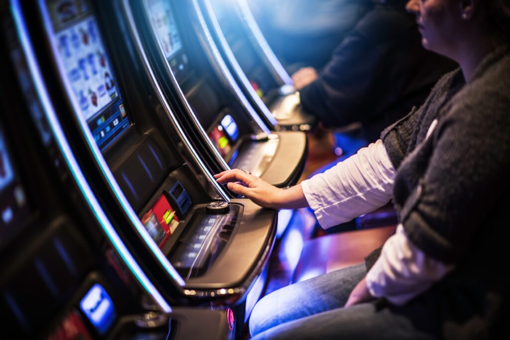 A photo of a person playing on a slot machine.