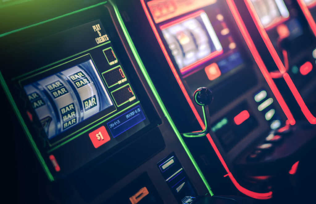 A photo of a slot machine that is displaying BAR symbols.