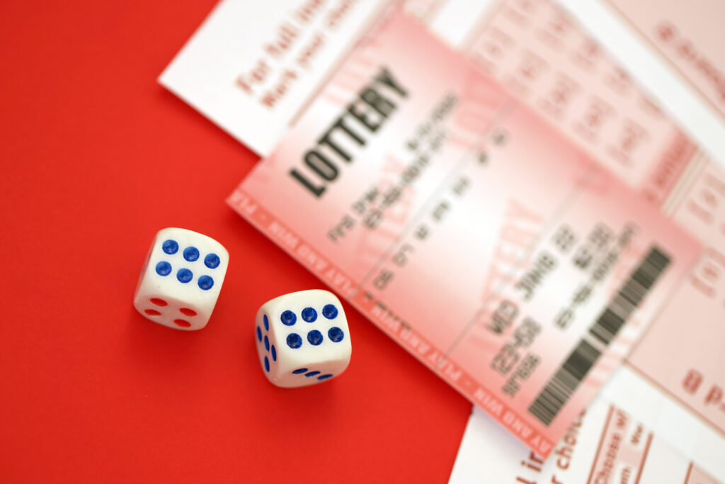 A photo of a lottery ticket and some dice.