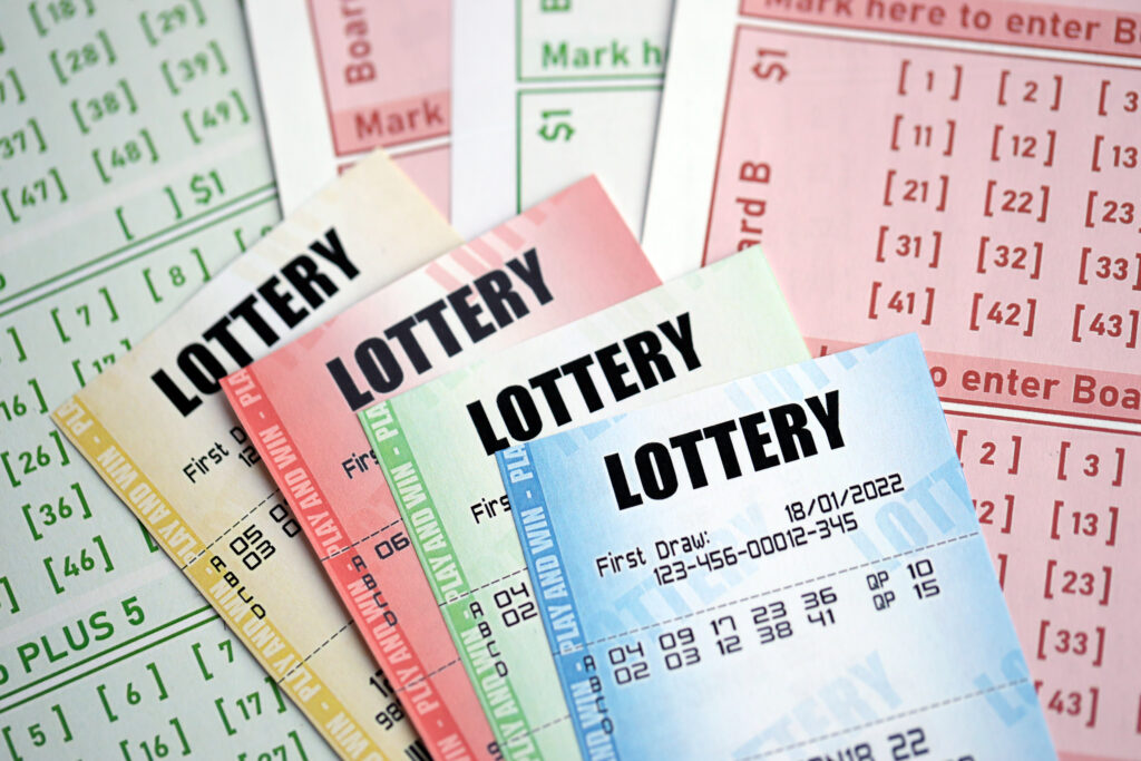 A photo of different coloured lottery tickets stacked on top of each other.