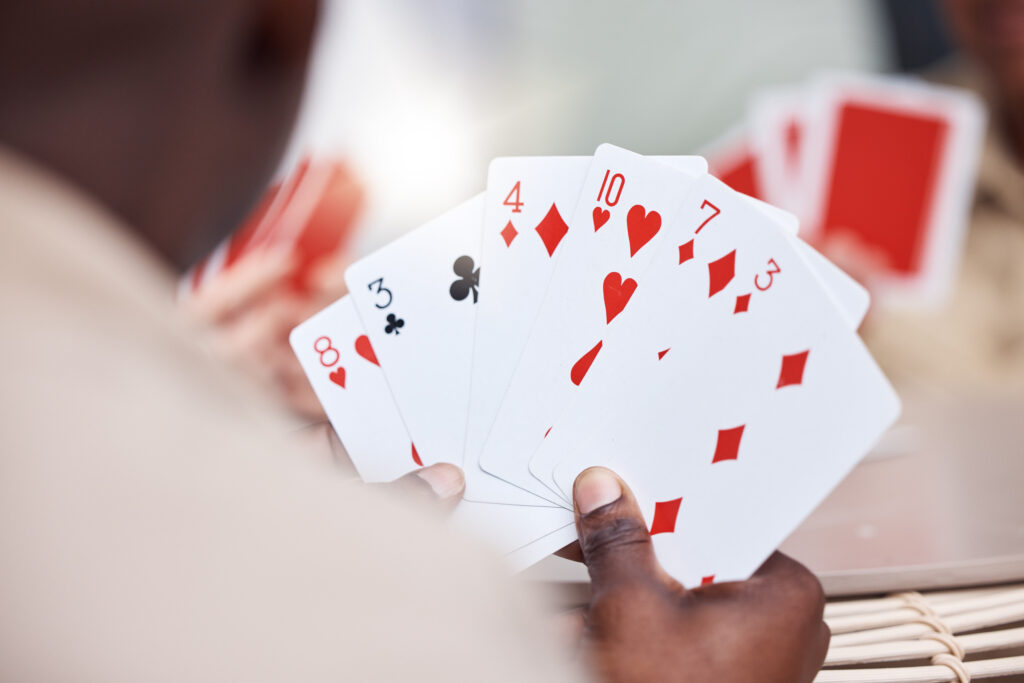 A photo of a person holding playing cards.