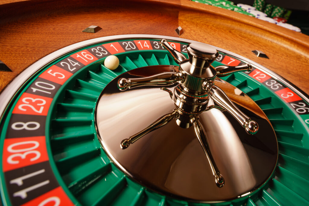 A close up photo of a roulette wheel in a casino.