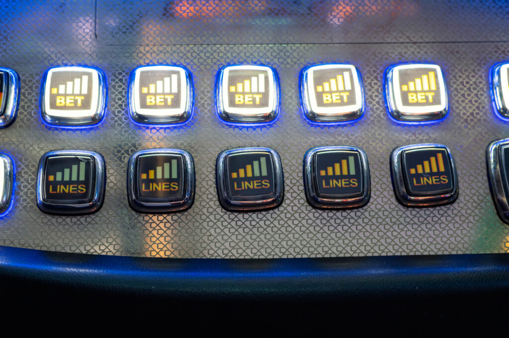 A close up photo of buttons on a slot machine.