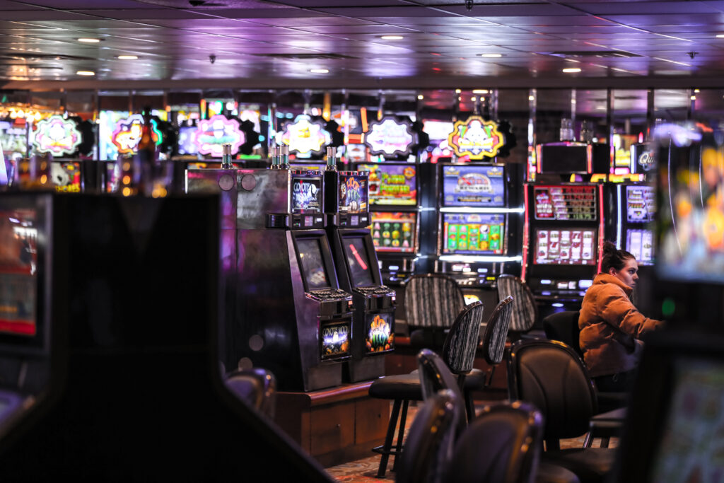 A photo of many slot machines in a casino.