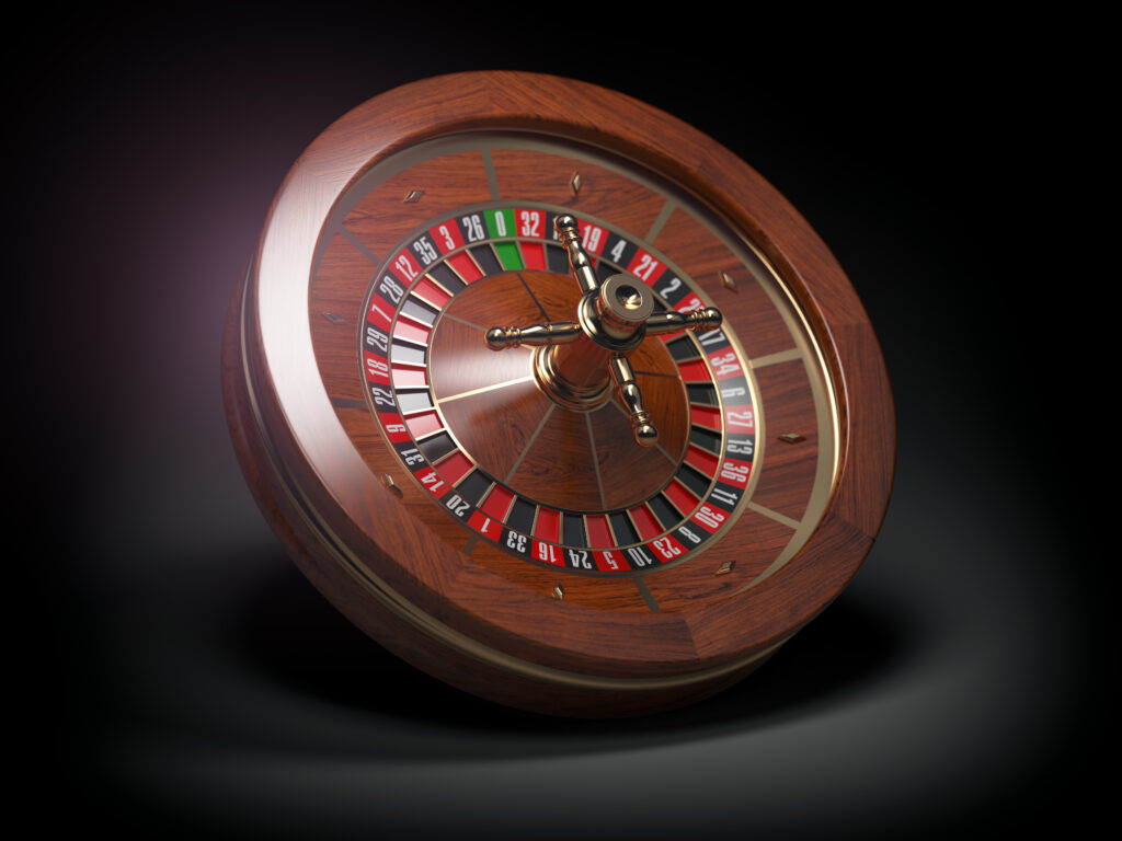 Roulette wheel angled on a black background.