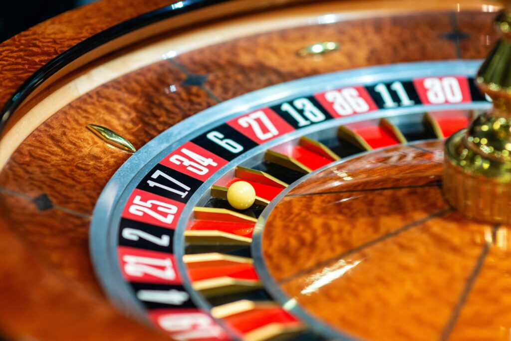 Close up of a roulette wheel with the ball on zero.