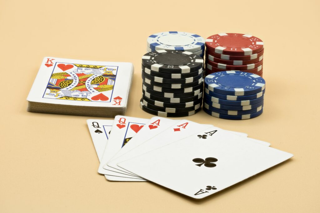 Playing cards besides stacks of casino chips.